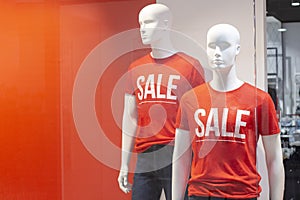 Part of a male mannequin dressed in casual clothes with the text sale in a shopping department store for shopping, fashion and adv