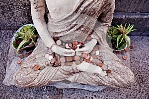 A part of the miditation sculpture with the money in front of a restaurant