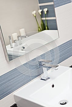 Part of modern bathroom in blue and gray tones