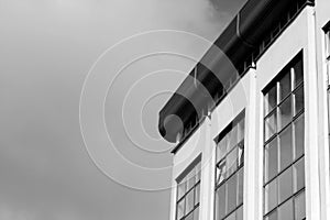 Part of modern building against sky in black and white