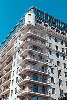 Part of Modern residential apartment building exterior. New luxury house and home complex. Copy space. Blue sky