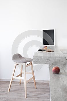 Part of modern scandinavian style kitchen: bar counter with bar counter and peaches.