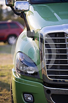 Part of modern semi truck with grille and headlight