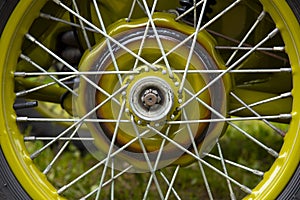 Part of a motorcycle wheel with spokes.