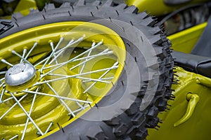 Part of a motorcycle wheel with spokes.