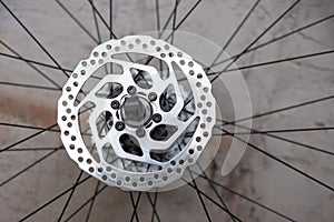 Part of Mountain Bike brake disc in close up. close-up disc brake bicycle wheel. Chrome steel bushing rim