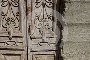 Part of an old brown wooden door with a pattern