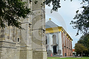 Part of the old tower of Sint-Lievens - monstertoren, with a view of the new church in the old town of Zieriksee, Netherlands