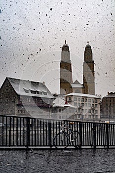 Part of old town in Zurich cower with snow with bicycle in photo