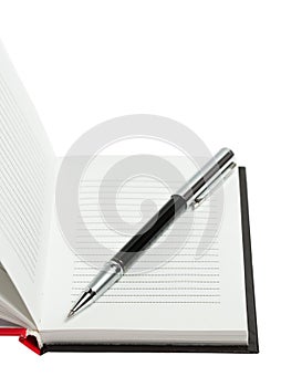 Part of opened notepad with pen. Isolated