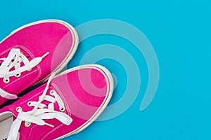 Part of the Pink sneakers with white laces on a blue