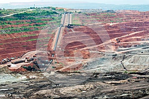 Part of a pit with big mining truck working.