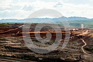 Part of a pit with big mining truck working.