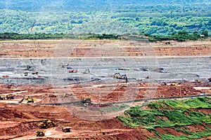 Part of a pit with big mining truck working.