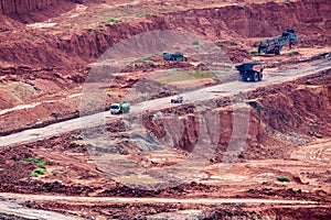 Part of a pit with big mining truck working.