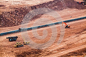 Part of a pit with big mining truck working.