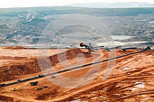 Part of a pit with big mining truck working.