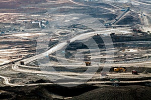 Part of a pit with big mining truck working.