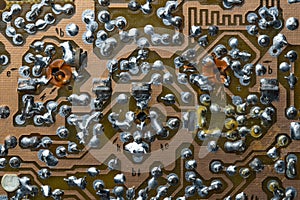 A part of a printed circuit computer board with tracks. PCB without radio components. Old printed circuit board background with