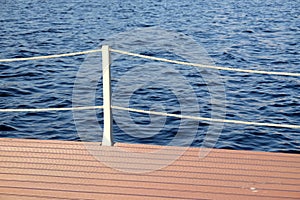 The part of the quay and the fencing with ropes from the water surface