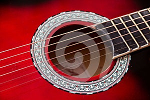 Part of red acoustic guitar. Close up