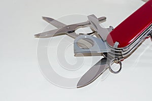 Part of red swiss pocket knife on white background