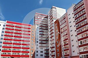 Part of residential building with many red loggias at summe