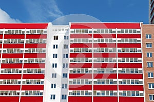 Part of residential building with many red loggias at sunny photo