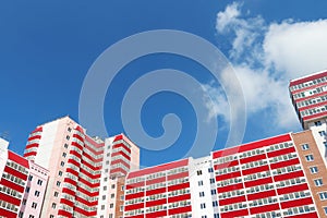 Part of residential building at sunny day, clouds