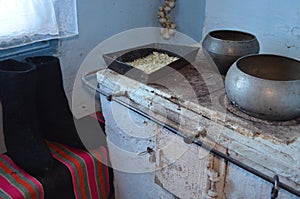 Part of the room with a stove near the window