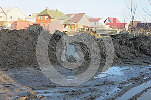 part of a rural road in brown mud and puddles