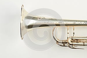 Part of rusty trumpet instrument.