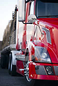 Part of semi truck modern red cabin trailer on parking lot light