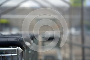 Part of a shopping cart with black handle. T photo