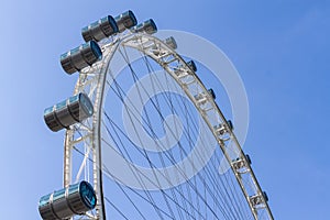 Part of Singapore flyer in blue sky