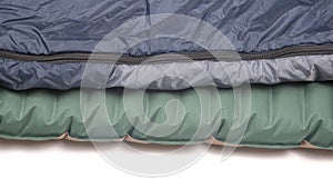 Part of a sleeping bag and an inflatable mattress for rest and sleep of a tourist