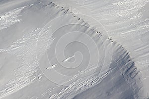 Part of a snowy mountain aerial photo without people and sky.