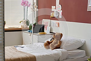 Part of spacious hospital ward in modern clinics with teddybear on bed
