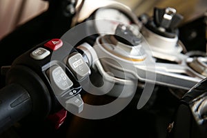 Buttons on the left handlebar of superbike. button of abs system on motorcycle.