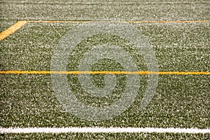 Part of sport soccer stadium and artificial turf football field. Detail, close up of green grass with white lines, goal line.