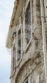 Part of a stone house with bars on the Windows in Cyprus