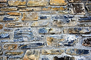 Part of a stone wall made of carved stone with different structure