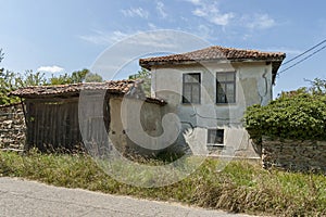 Part of street in the Paunovo village with old house, tree and fence, Sredna Gora mountain