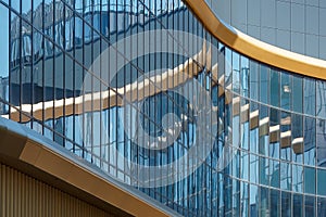 Part of a super modern business building against the blue sky