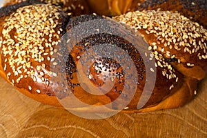 Part of the Sweet Slavic bun, close-up, and called Kalach, on a wooden board