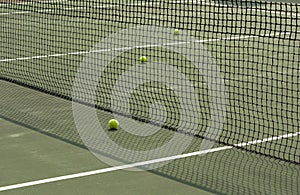 Part of tennis court with net and balls