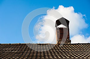 A part of tiling roof with chimney heaven background