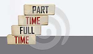 Part time and full time written on wooden blocks and light background. Business concept