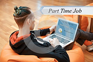 Part time job concept. A young man works at a computer