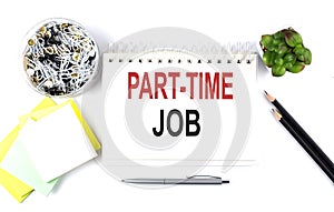 PART-TIME JOB text on notebook with office supplies on white background